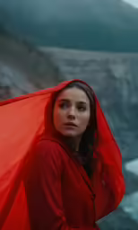 a woman in a red dress holding an umbrella
