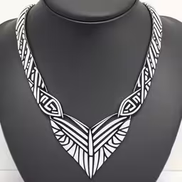 an art nouveau necklace on display with black background,a necklace with an ornate design on a mannequin,a white necklace is shown on a black dummy,a necklace on a mannequin wearing a neck piece,a necklace is shown on display with the collar in black and white
