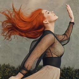 a woman wearing a sheer bodysuit, with long hair flying in the wind
