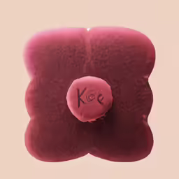 a cushion with a needle on it on a pink background