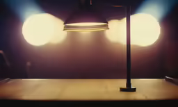 a floor lamp in front of a table