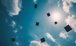 several square objects flying through the air in the sun
