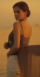a woman in tight pants leaning on a ledge