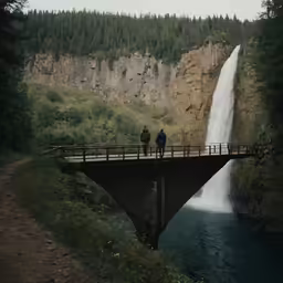 two people looking out into the distance at a waterfall