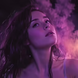a woman with wet hair looks up at a cloud of smoke