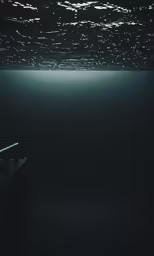 a dark room with some light on the ceiling