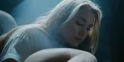 a woman has her eyes closed and looks down