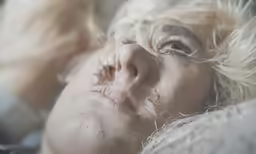 a woman in bed covered with mucus and wet nose