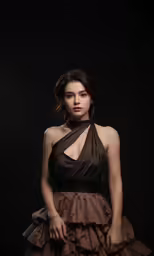 a woman in a dress is standing with her hands on her hips