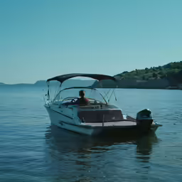 a man is on a small boat in the water