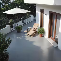 a wooden chair on a patio next to a deck