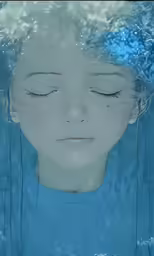 an artistic photograph of a girl with closed eyes under water