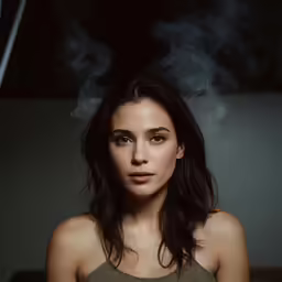 the woman is standing in front of a burning cigarette