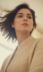 a young woman standing with her hair flying