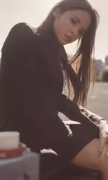 the woman is sitting down with her legs crossed