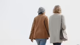 two women walking towards the camera