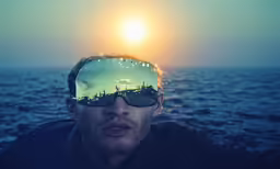 man with goggles on while standing by water
