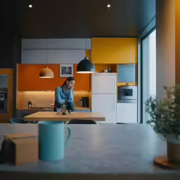 the woman is sitting on a kitchen counter