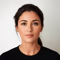 a woman with makeup looking into the camera