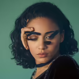 an image of a woman with black makeup