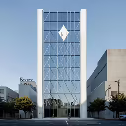 a tall building sitting on the side of a road next to buildings