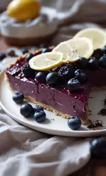 a berry cheesecake with lemon slices and chocolate shavings