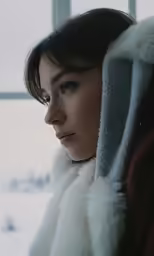 the woman is wearing a furry coat outside