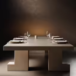 the table has glasses on top of it and plates are in front of it