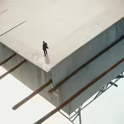 a person standing on the concrete of a bridge