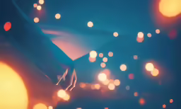 a person standing in front of blurry lights