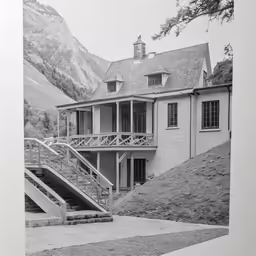 an old photograph of a house that is on the corner