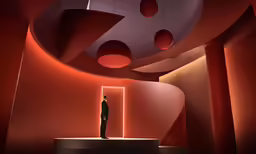 a suit man standing in front of some round lights