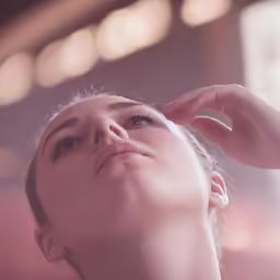 a young woman is getting her hair combed