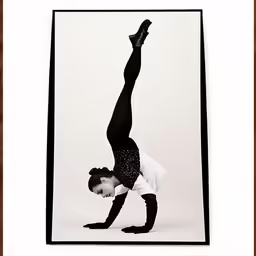 a girl is balancing on her legs in a pose
