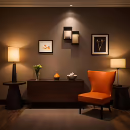 a bright orange chair is set against a dark wall