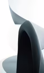 the back of a modern white chair with curved seats