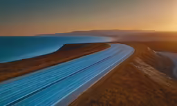 the highway next to the beach leads into the sunset