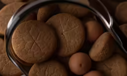 a basket of cookies and brown eggs with a spoon