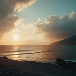 a very nice looking beach at sunset with some waves