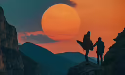 two people standing on top of a mountain