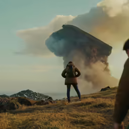 a person looking at the sky near a huge cloud