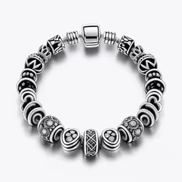 a bracelet that has a silver charm on it,a silver bracelet with a celtic pattern on it