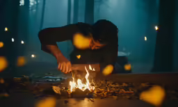a man putting candles in the shape of heart on fire