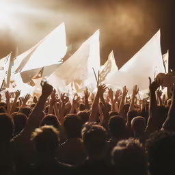 a group of people holding their hands up