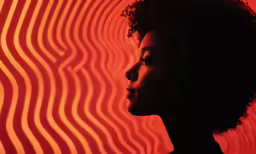 the profile of a woman standing in front of wavy background