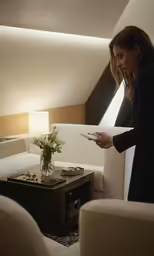the woman is looking at the piece of paper in the room