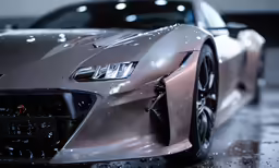 a silver sports car is driving on a wet parking lot