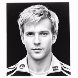 a young man posing for a black and white photo