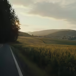 a long and winding highway that has a very beautiful sunset