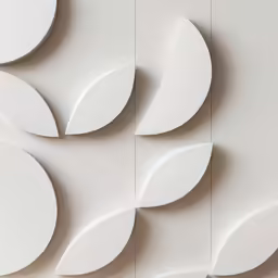 white circles with black details on them against a wall